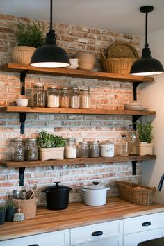 some shelves with pots and pans on top of them in front of a brick wall