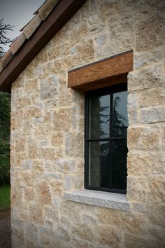 a window on the side of a stone building