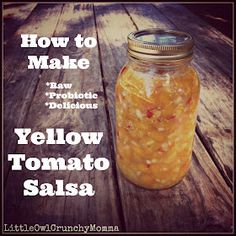 a jar filled with yellow tomato salsa sitting on top of a wooden table next to the words, how to make raw probiotic