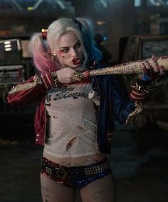 a woman with pink hair holding a baseball bat