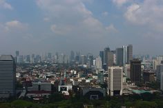 an aerial view of a city with tall buildings and skyscrapers in the foreground