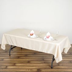 a table with two glasses on it and napkins in front of the table top