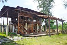 a wooden house sitting on top of a lush green field