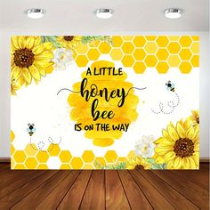 a wall mural with sunflowers and bees on it, that says a little honey bee is on the way