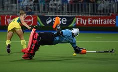 two men are playing field hockey on the field