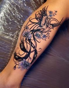 a woman's leg with tattoos on it and flowers in the middle of her arm