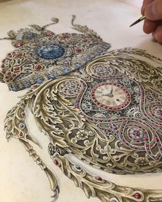 a person is drawing on a piece of paper with colored pencils and an ornate clock