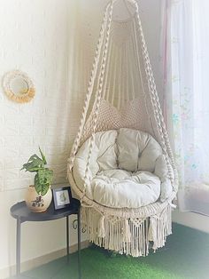 a hammock chair hanging in the corner of a room