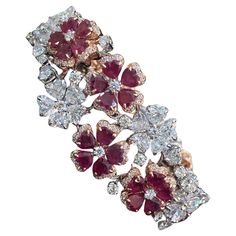 This exquisite bracelet showcases a total of 14.88 carats of heart and round-cut natural diamonds, complemented by a stunning 16.50 carat heart-shaped ruby, all set in lustrous 14K two-tone gold. An ideal choice for any occasion, it makes for a truly memorable gift! Specifications : Gemstone : Natural 16.50 Carats Heart Shape Ruby Length : 7 Inches [Custom Length Available] Width : 24.25 MM Diamond Weight : 14.88 Carats Diamond Shape : Heart & Round Diamond Color Grade : G Diamond Clarity Grade : SI1 Gold Color : Multi-Tone Gold Purity : 14Karat Our Promise : 1.) HIGH Quality Products. 2.) All our products are accomanpied with Hallmark Stamps and Certificates. 3.) We have all sizes, shapes, color, clarity GIA & IGI Ceritifed Diamonds Available. 4.) We do make Custom Designs. Please contact Bracelet Tennis, Modern Bracelets, Diamond Color Grade, Diamond Color, Diamond Shape, Tennis Bracelet, Diamond Clarity, Memorable Gifts, Diamond Shapes