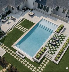 an aerial view of a house with a pool and patio area in the foreground