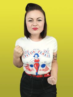 "Hurry! Hurry! Step right up! See the certain female you've all been waiting for! Complete with fairground and big tops, our sideshow strong woman design is screen printed onto 100% natural cotton, giving it that authentic 50's look and feel. \"You Wanna Be Americano?\" Then land an opportunity with this gorgeous garment, which pairs perfectly with dark denim. Designed and finished in the North East of England 100% Cotton Crew Neck  Short Sleeved T-Shirt. Screen Printed. This is an original vint Fitted Rockabilly Tops With Graphic Print, Retro Short Sleeve Tops For Retro-themed Events, Rockabilly Graphic Print Short Sleeve Top, Rockabilly Style, 50s Look, Rockabilly Mode, 50s Rockabilly, Rockabilly Fashion, Dark Denim