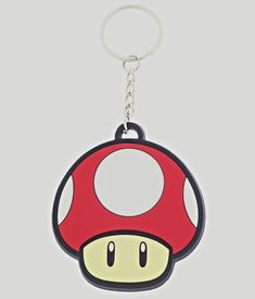 a mushroom shaped keychain is shown on a gray background with a white circle in the center