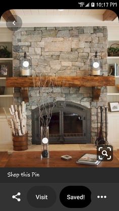 a living room with a fire place and stone fireplace mantel in the center, surrounded by bookshelves