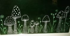 a chalk board with mushrooms painted on it