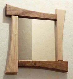 a wooden mirror hanging on the wall