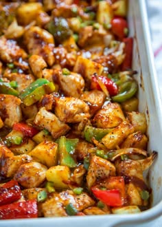 chicken and peppers in a white casserole dish