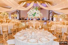 the tables are set with white flowers and candles for an elegant wedding reception at the four seasons resort