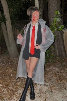 a woman dressed up as a zombie in the woods