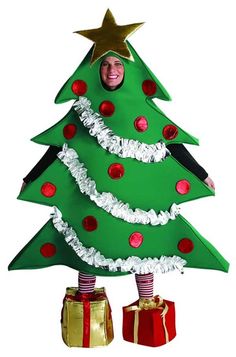 a cardboard christmas tree with presents under it and a smiling child in the middle,