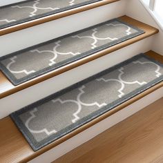 three carpeted stair mats on the bottom of stairs