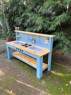 a blue outdoor kitchen with sink and stove