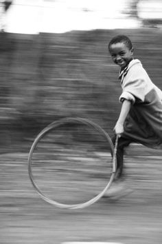 a young boy is playing with a large object