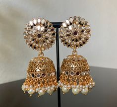 Gold Mirror Polki Jhumka. Handcrafted pair of earrings. Gives a traditional look. Can be worn for engagement and wedding parties. Ethnic Wear. Indulge in it or gift it and watch the compliments flow! Length: 3 inch Width: 1.5 It is advisable to store jewelry in a zip lock pouch (air tight pouch), keep away from water perfume and other chemicals and clean it with soft cloth. FREE SHIPPING!! Pakistani Earrings, Water Perfume, Store Jewelry, Bollywood Jewelry, Wedding Parties, Gold Mirror, Ethnic Wear, Beautiful Earrings, Chemicals