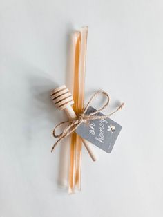 two candles tied with twine on white surface