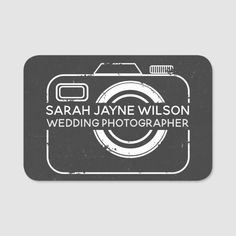 a black and white sticker with the name of a photographer