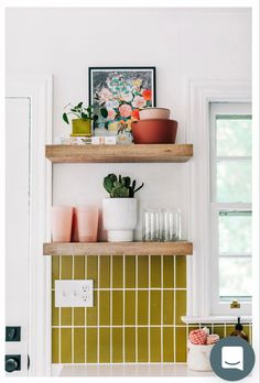 two wooden shelves filled with pots and plants on top of a white kitchen countertop