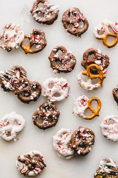 an assortment of doughnuts with sprinkles and candy caned on them