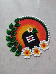 a hand painted sticker with flowers and leaves around it