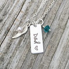 This beautiful necklace is the perfect way to remember a loved one. Silver necklace comes with an aluminum tag hand stamped with your loved one's name and a heart stamped after the name, a genuine Swarovski crystal birthstone charm, an angel wing charm, and a Swarovski pearl. Also available in sets of 2 or more at a discounted price. My items are hand stamped by me, making them a unique gift. Each letter is stamped individually and may not line up exactly adding to the charm and uniqueness of th Mother's Day Hand Stamped Dog Tag Jewelry, Hand Stamped Dog Tag Jewelry For Anniversary, Personalized Hand Stamped Dog Tag Jewelry, Personalized Dog Tag Charm Necklaces For Anniversary, Personalized Dog Tag Charm Necklace For Anniversary, Adjustable Hand Stamped Necklaces For Father's Day, Personalized Hand Stamped Charm Necklaces, Adjustable Stainless Steel Charm Necklace For Anniversary, Father's Day Hand Stamped Dog Tag Necklaces