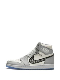 Wolf grey/sail white leather x Dior Air Jordan 1 High sneakers from JORDAN featuring round toe, flat rubber sole, front lace-up fastening, branded insole, monogram pattern and ankle-length. These styles are supplied by a premium sneaker marketplace. Stocking only the most sought-after footwear, they source and curate some of the most hard to find sneakers from around the world. | Jordan x Dior High sneakers Air Jordan X Dior, Shoes Retro, Jordan 1s, High Sneakers, Air Jordan 1 Retro High, Air Jordan 1 High, Jordan 1 High, School Fits, Air Jordan 1 Retro