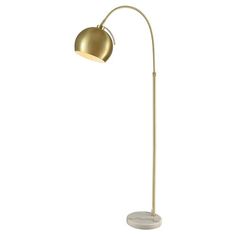 a floor lamp with a marble base and gold colored shade on the top, standing in front of a white background