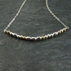 Share a secret message with a loved one. This morse code necklace is a sentimental gift perfect for that special someone that loves unique gifts. The necklace pictured, spells "LOVE" but a name or any word can be used in this necklace. Details - The necklace is 16 inches and includes an extra 2 inch extender. - Gold filled beads separate each letter in the morse code message. - Choose from words with up to 8 letters. Materials - Sterling silver flat cable chain - Sterling silver components - Ste Spiritual Silver Necklaces For Friendship, Minimalist Silver Necklaces For Friendship, Minimalist Silver Necklace For Friendship, Spiritual Necklace With Satellite Chain Gift, Spells Love, St Michael Pendant, Morse Code Necklace, Silver Gold Necklace, Gold Jewelry Necklace