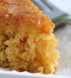 a close up of a piece of cake on a plate with a fork in the background