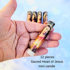 someone is holding some fake candles in their hand with jesus pictures on them and the words, 12 pieces sacred heart of jesus mini candle