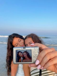 two women taking a selfie on the beach