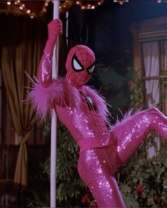 spider - man in pink sequinized costume on pole