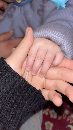 two people holding each other with their hands