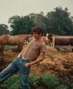 a man standing in front of some horses