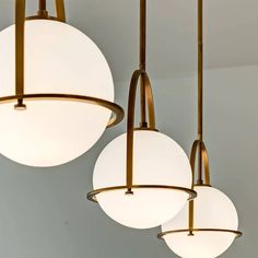 three circular lights hanging from the ceiling in a room