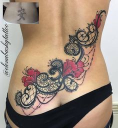 a woman's stomach with an intricate tattoo design on the side, and red flowers