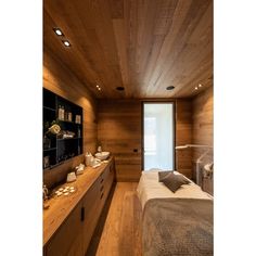 a bedroom with wooden walls and flooring