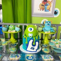 a table topped with cupcakes and cakes covered in blue frosted icing