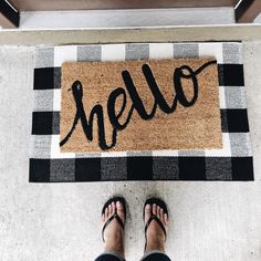 someone standing in front of a welcome mat with the word mello written on it