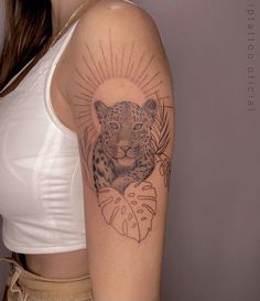 a woman with a leopard tattoo on her arm