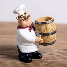 a small figurine is holding a wooden barrel