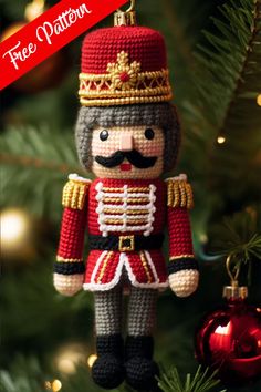 a crocheted nutcracker ornament hanging from a christmas tree